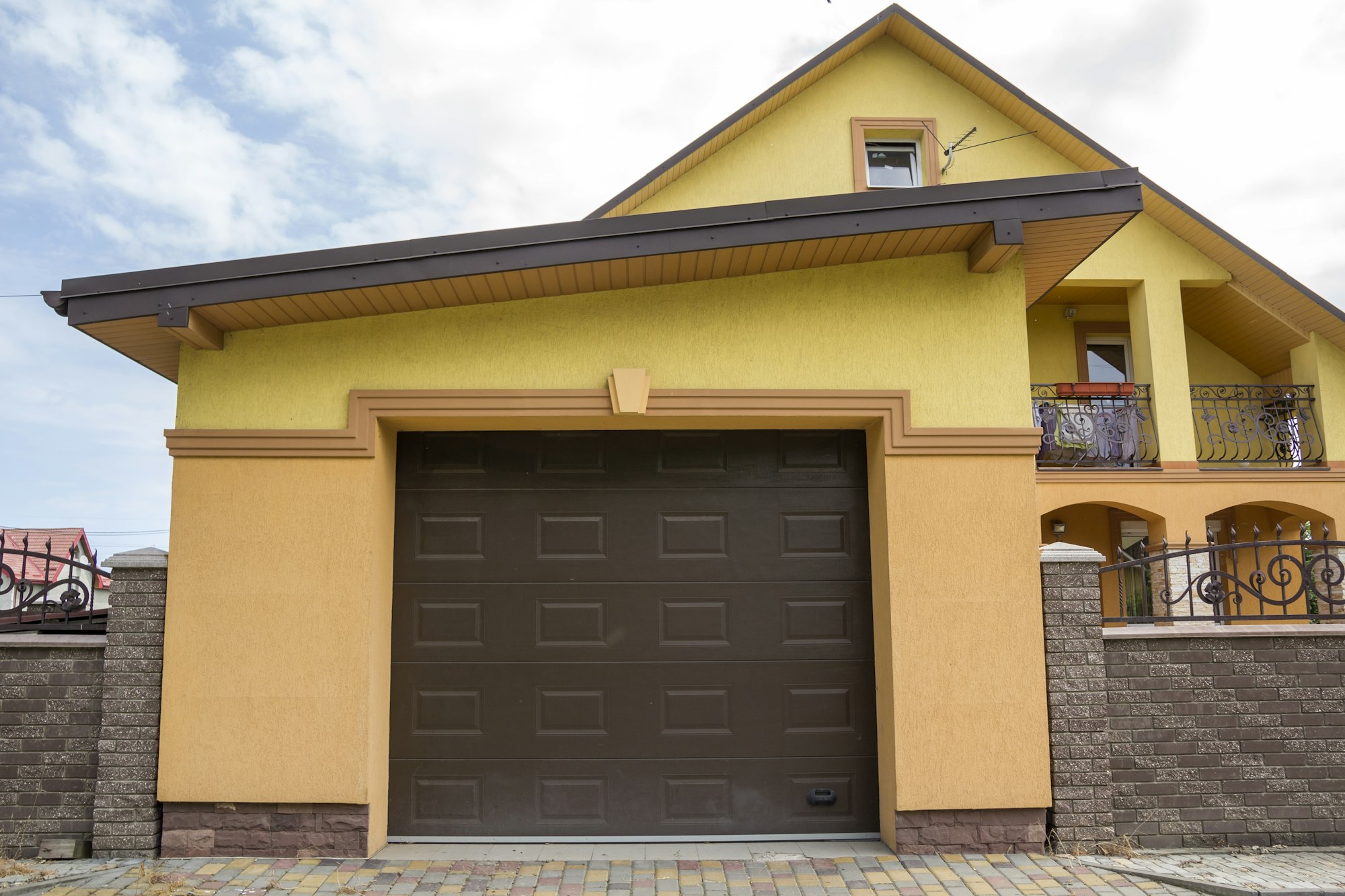 View from the clean paved street of detached garage with big automatic door